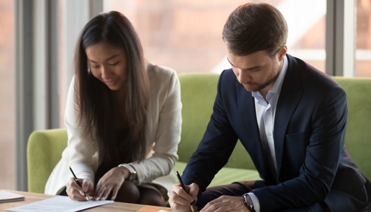 a young couple signs a prenuptial agreement