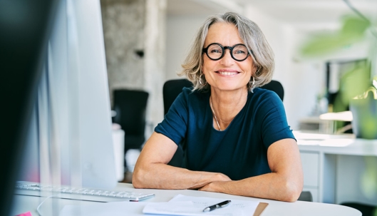 A smiling woman with glasses