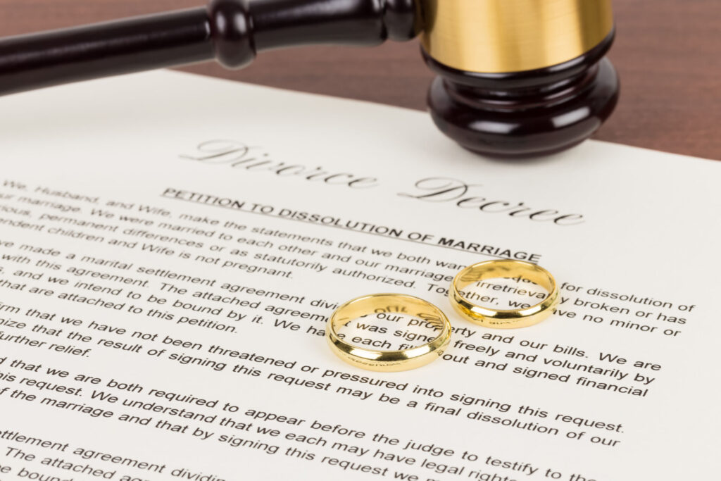 A wedding ring and a petition to dissolution of marriage paper